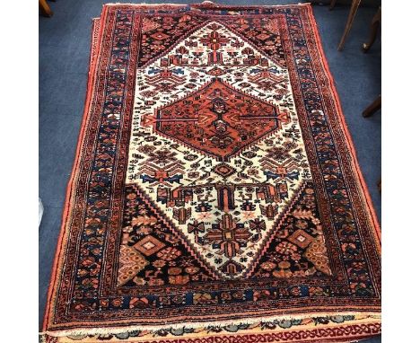 20TH CENTURY RUG, with geometric designs in red, cream and blue, along with another rug with Celtic designs on a red ground (