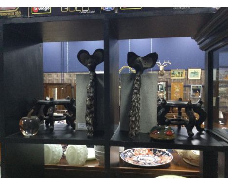PAIR OF DECORATIVE BOOKENDS, along with two Chinese hardwood stands, a Caithness paperweight and a paperweight modelled as an
