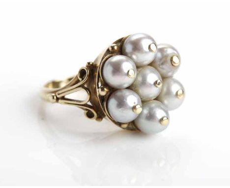PEARL DRESS RING
the bezel 16mm across and set with seven pearls, on ornate scroll motif shoulders, in fourteen carat gold, s