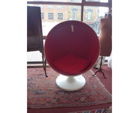 A vintage 1970's ball chair upholstered in red fabric 