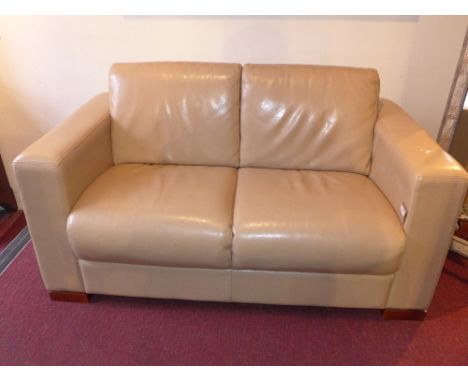 An Art Deco style two seater sofa upholstered in beige leather 