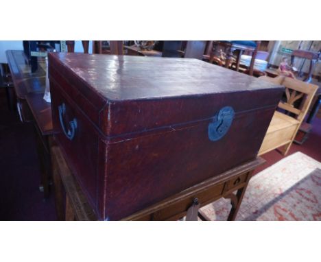 A Chinese trunk of burgandy hue, having twin handles 