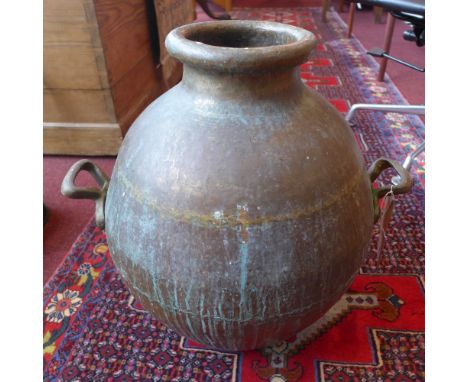 A bulbous twin handled copper planter 