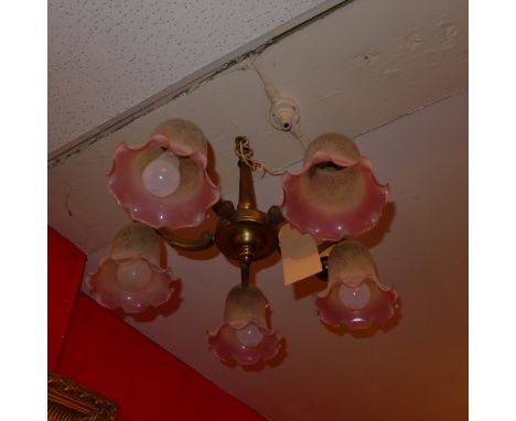 A vintage brass five branch chandelier having frosted glass shades 