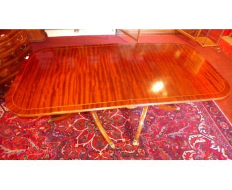 A Regency style mahogany twin pillar dining table with one extra leaf and the matching set of six chairs 