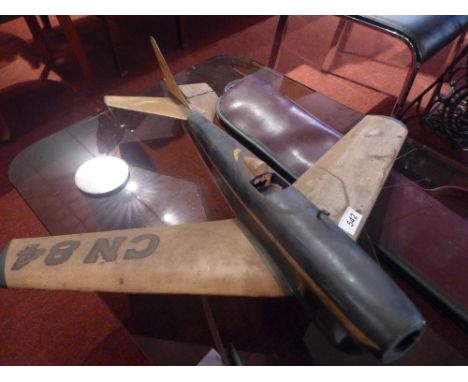 A vintage aeroplane together with a Willie Thorn snooker cue