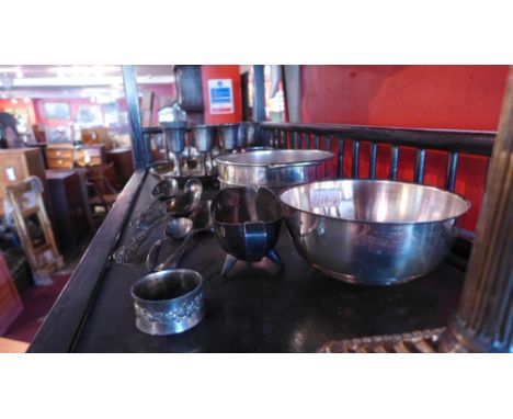 A large quantity of silver plated items to include a Corinthian column candlestick engraved trays, spoons, goblets and bowls 