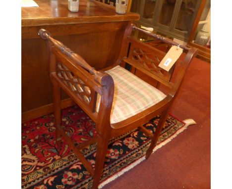 An Edwardian design mahogany piano stool having pierced sides 