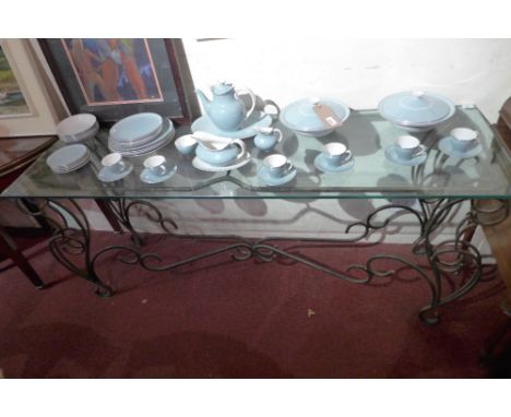 A wrought iron serpentine fronted console table with heavy plate glass top 