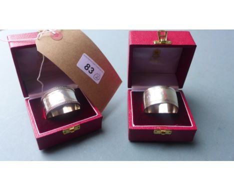 Two Asprey hallmarked silver napkin rings in original boxes