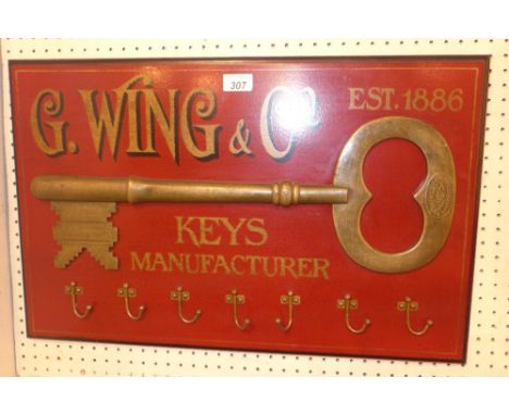 A vintage style Wing and Co key manufacturer advertising sign coat hook  