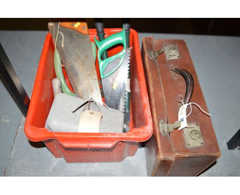 A box of saws and garden tools; together with a small leather case.