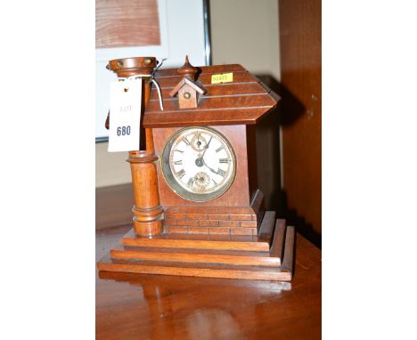 An oak mantel clock of cottage form, with roman dial and subsidiary apertures.