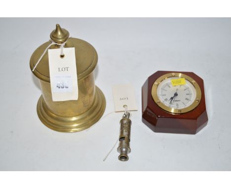 A brass door stop; a reproduction ship's style clock in brass and mahogany mount; and a chromed brass policeman's whistle.