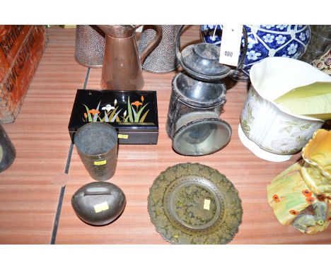 A metal railway lamp; an Indian brass beaker and plate; a metal cow bell; and a lacquer cigarette box.