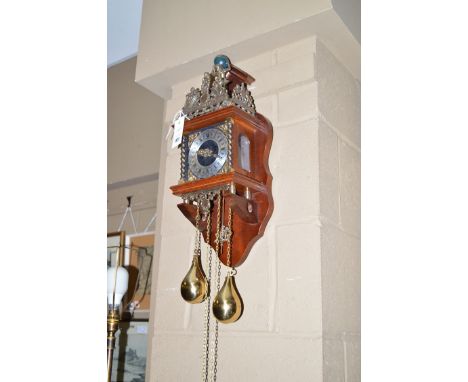A modern stained wood, glass and brass wall clock.