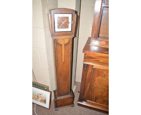 An Art Deco oak granddaughter clock with arabic dial.