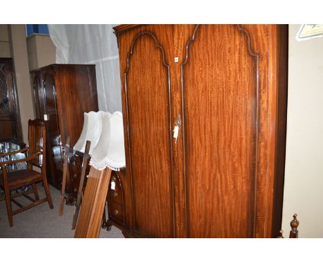 A modern mahogany three-piece bedroom suite with shaped arch panels, to include: a wardrobe, a lady's wardrobe, dressing tabl