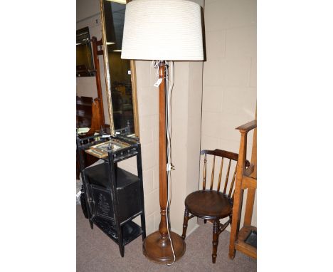 A 20th Century mahogany standard lamp, the tapering hexagonal column above a baluster stem and turned circular base.