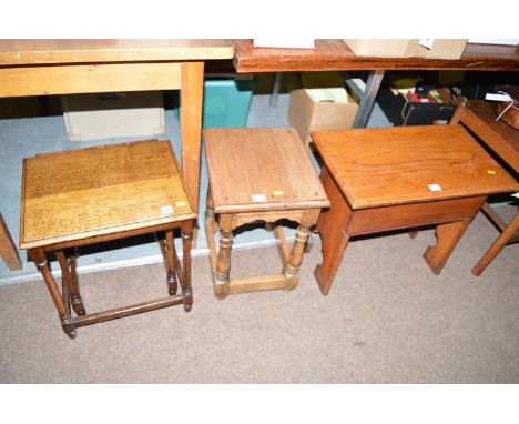 A nest of two oak tables; together with a stripped oak stool, raised on turned legs joined by square stretchers.