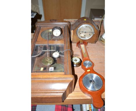A late 20th Century wall clock in stained wood case; a mantel clock in oak case; a small barometer; another in a bakelite cas