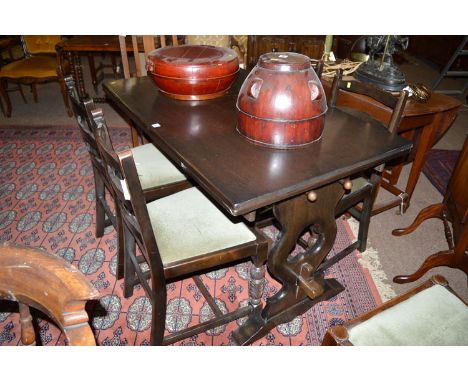 A dark stained oak dining suite, to include: a rectangular extending dining table, raised on pierced vase-shaped legs; four l