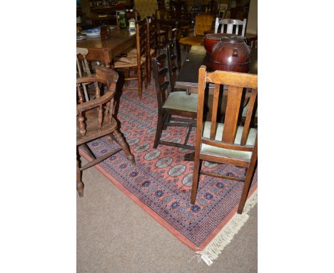 A modern machine-made carpet with tekke medallions overall.