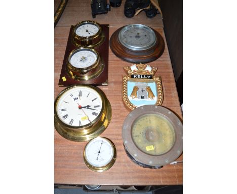 A ship's boat compass; a brass ship's quartz and barometer on board; a cork clock; two barometers; and a plaque inscribed Kel