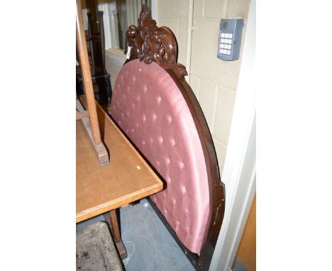 A Victorian style mahogany carved and button backed headboard; a walnut bedside cabinet with single cupboard door.
