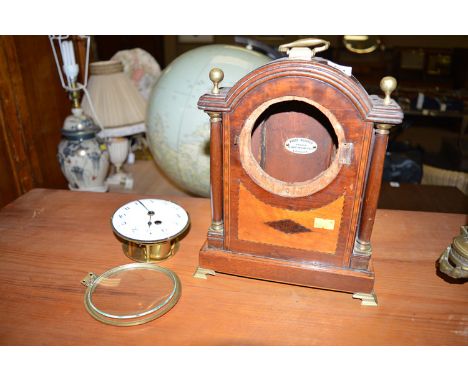 An early 20th Century mahogany and satinwood inlaid mantel clock, the white enamel roman dial fitted an arch topped case, bra