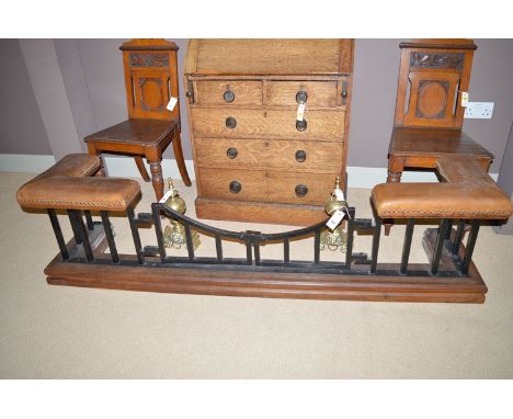 An early 20th Century club fender with leather padded seat corners, above cast iron guard with gate action centre, raised on 