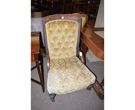 A Victorian oak nursing chair, carved with fan motifs to cresting rail, upholstered in button backed cut velvet material and 