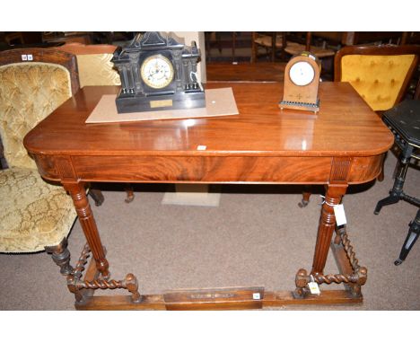 An early 19th Century mahogany D-end side table with reeded panels to frieze, raised on turned reeded tapering legs terminati