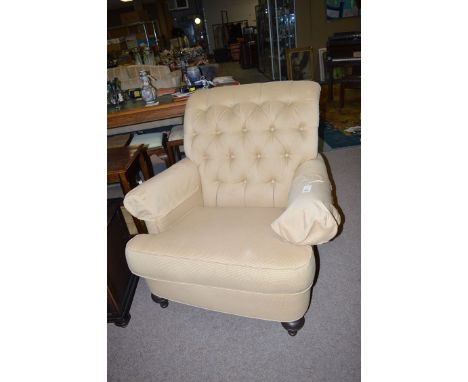 An Ethan Allen Home Interiors button-back easy chair, raised on turned tapering legs.