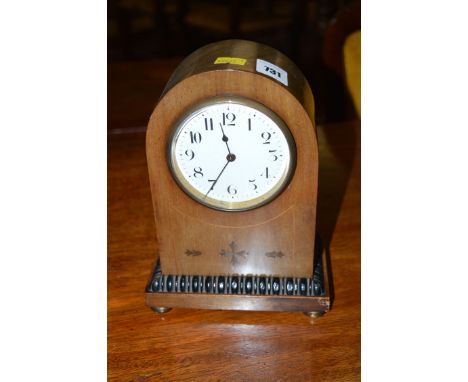 An Edwardian brass inlaid mahogany mantel clock, the white enamel arabic dial within domed case and reeded base.