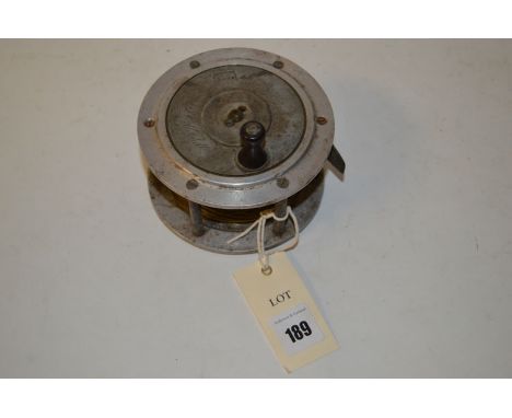 A large heavy aluminum fly reel, stamped Anderson Dunkeld and engraved J. C. Mitchell Glasgow.
