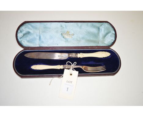 A presentation knife and fork with carved ivory handles and silver blade/prongs, by H.W. & Co., Sheffield 1867, in fitted cas
