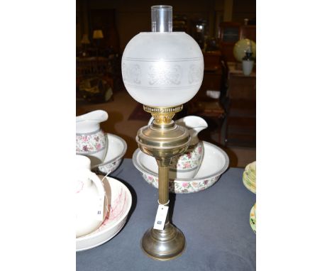 A late 19th Century oxidised table oil lamp with opaque shade and brass chimney.