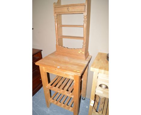 A stripped pine wall shelf with underlying drawer; together with a moveable butcher's block with two undertiers.  (2)