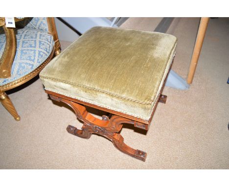 A Victorian walnut stool with green dralon upholstered seat, raised on X-form legs joined by turned stretcher.