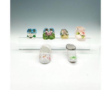A set of figural antique or vintage shoes. Includes an H.P. Babies ceramic shoe. A delicate child's porcelain shoe with strap