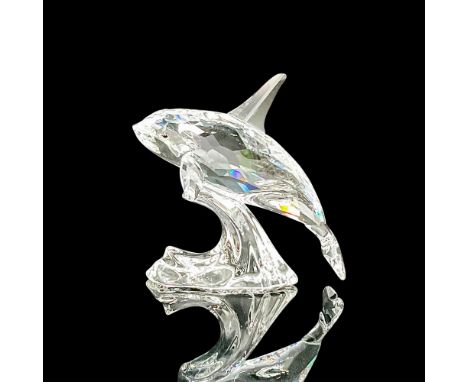 Part of the 'South Sea' collection, a clear crystal whale riding a smooth wave. Blue-green crystal eyes. Swarovski etched mar