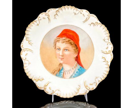 Hand painted porcelain decorative plate with an image of a pretty young lady in a blue blouse and red scarf tied around her h