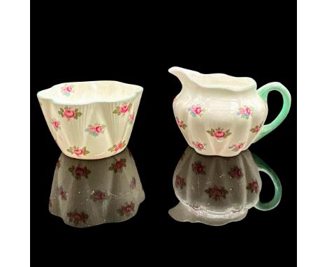 White bone china with pink rose motif, light turquoise rim. Creamer pitcher 4.25"L x 3.25"W x 2.75"H. Sugar bowl 2"H x 3.5"di