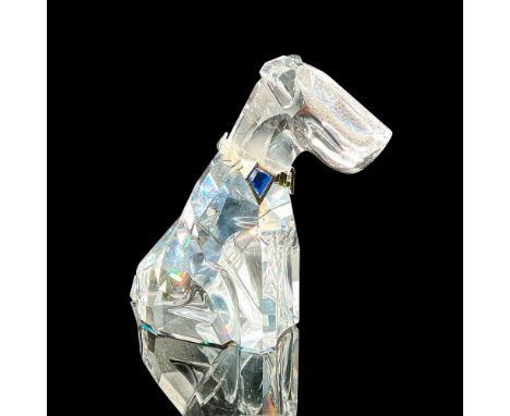 This faceted clear crystal Dog is an exquisite figurine that captures the charm and elegance of man's best friend. He wears a