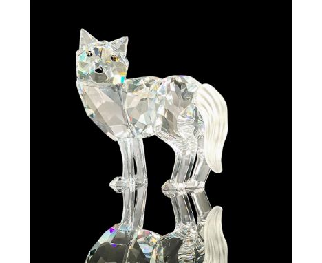 Sparkling faceted crystal figurine modeled as a wolf with head turned over its shoulder. Brown eyes and frost finished tail. 