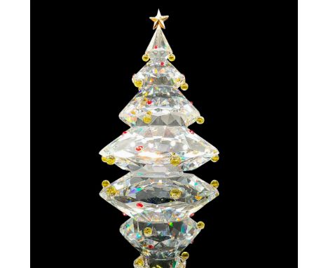 Sparkling faceted crystal figurine modeled as Christmas tree decorated with red gems, gold star, and yellow beads. Swarovski 