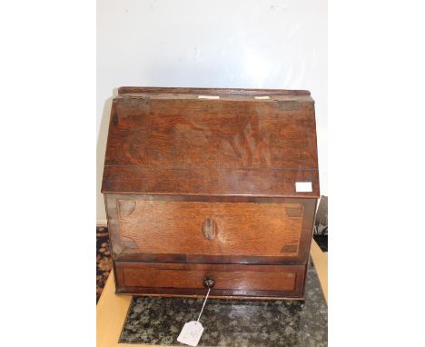 An 18th Century oak candle box with crossbanded ad inlaid panel to the front and crossbanded drawer to the base 