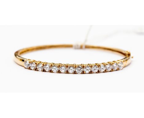 A 9 ct gold and cubic zircona set to the top bangle, total gross weight approx 12.5 grams