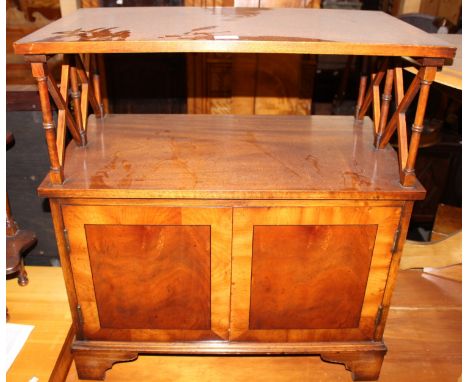 A 20th Century yew wood  side unit, with a shelf section and two cupboard doors below